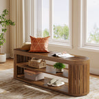 Shoe bench by a window with a cushion, basket and shoes on the lower shelves