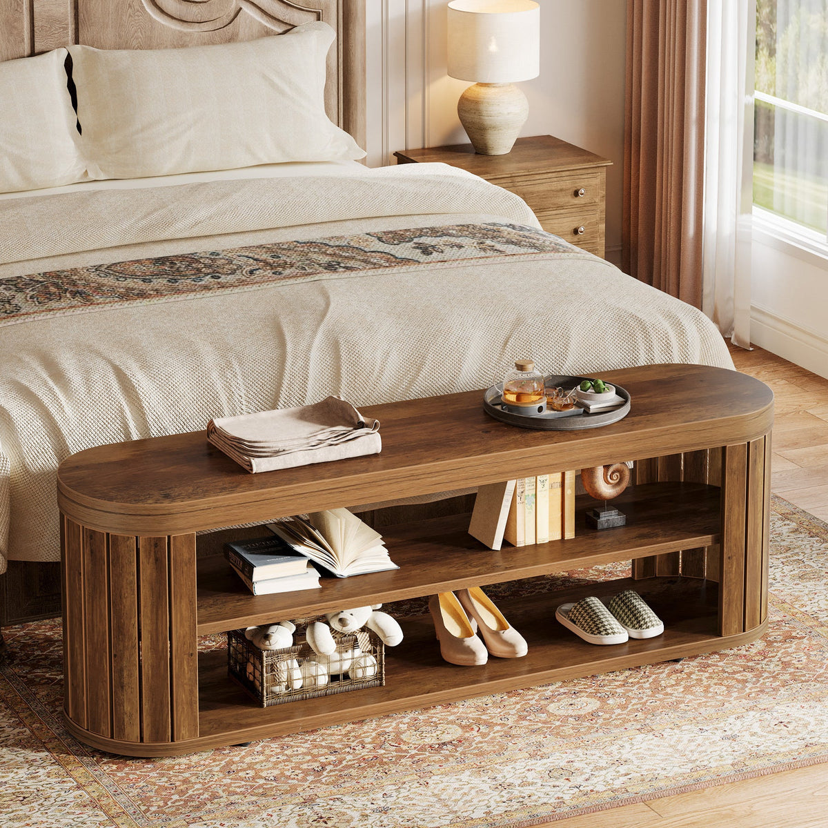 Bench at the end of a bed holding books and shoes on its two tiers