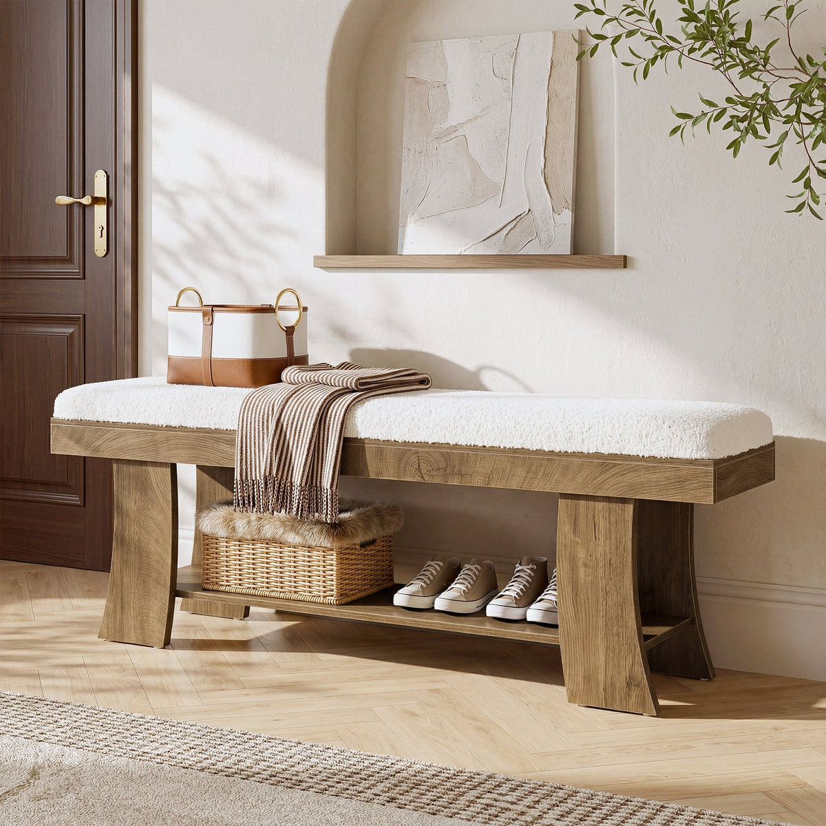 Stowena 59 inch upholstered entryway bench with white cushion, blanket and baskets underneath