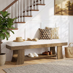 Cushioned shoe bench under a staircase with hat and slippers on the lower shelf