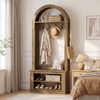 Hall tree in a bedroom corner with a hat and clothes on the hooks and shoes below