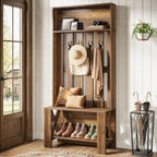 Farmhouse hall tree with hat and bag on hooks beside a bright window