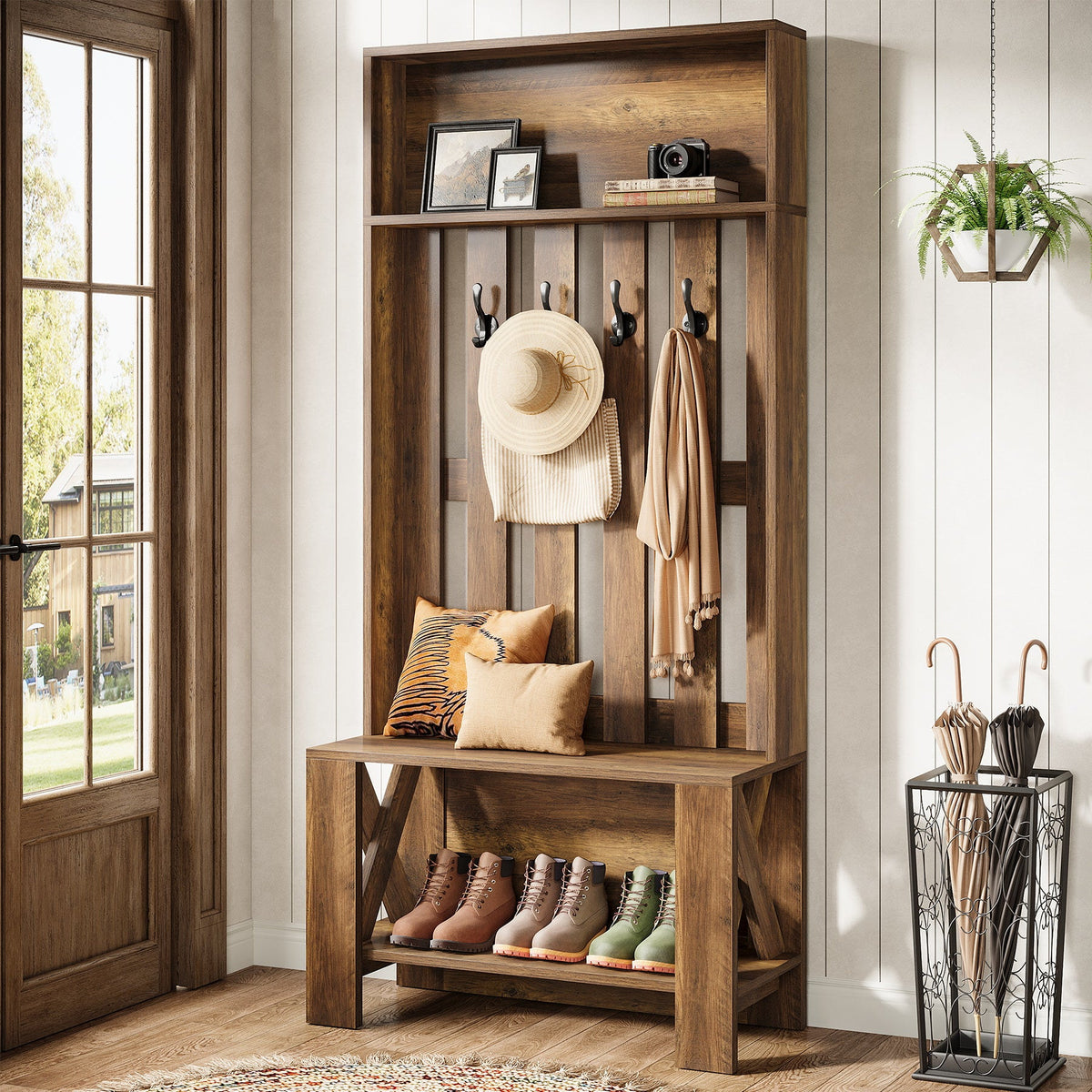 Farmhouse hall tree with hat and bag on hooks beside a bright window