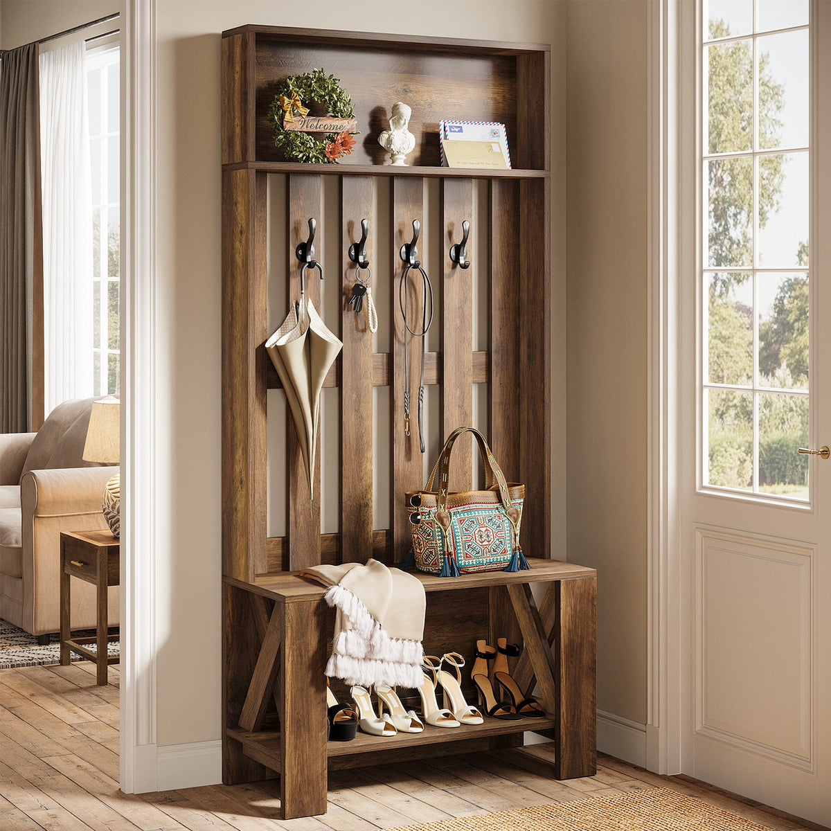 Slim coat rack bench with hanging bags and shoes below in a white hallway