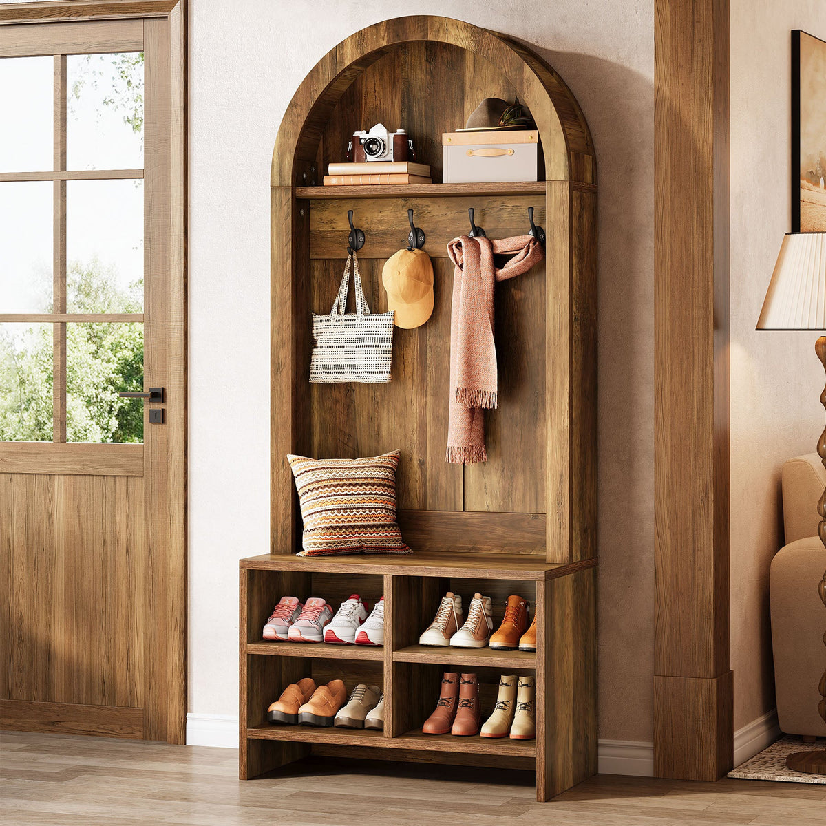 Arched hall tree beside a front door with a scarf and bag on the hooks