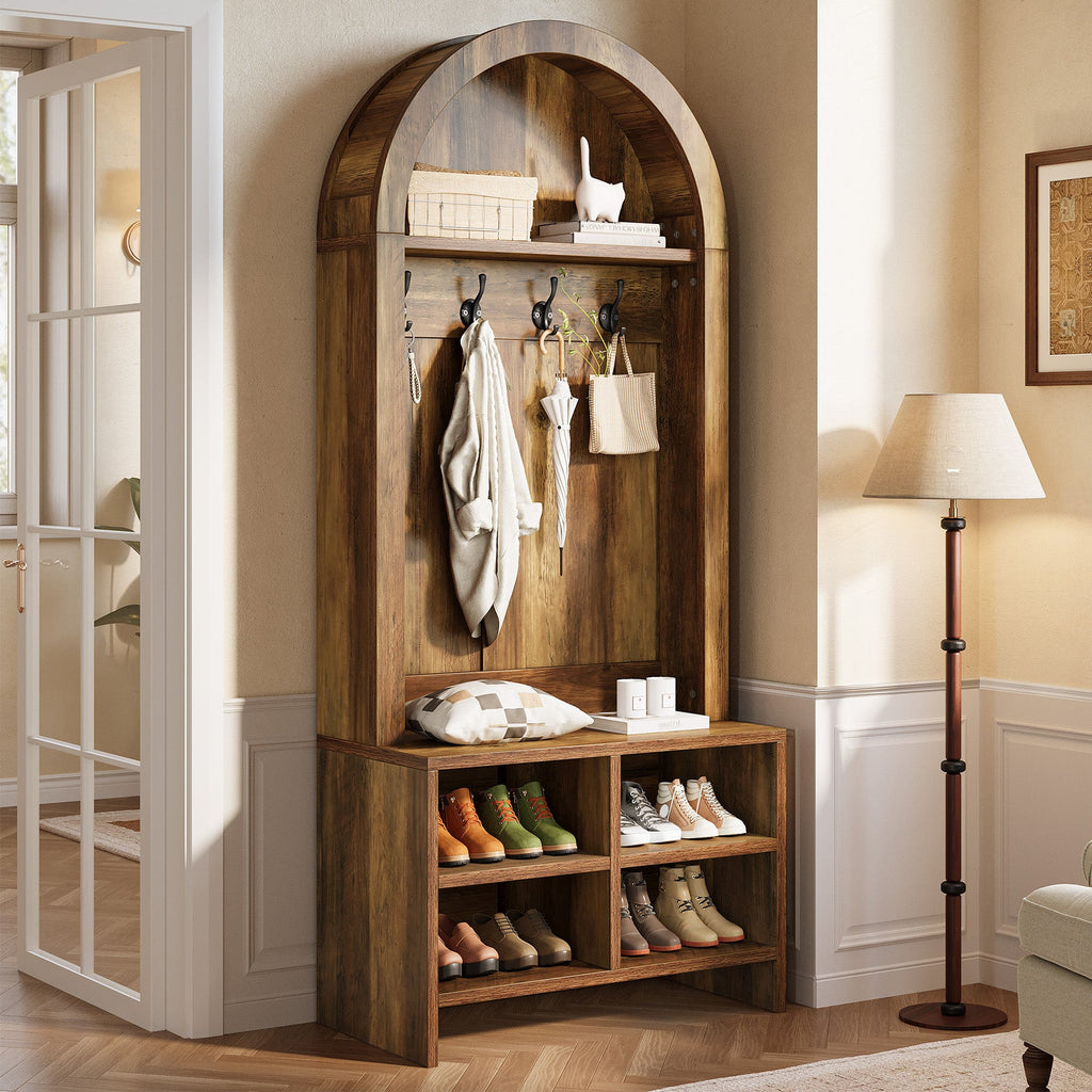 Arched entryway hall tree with coats beside a hallway lamp