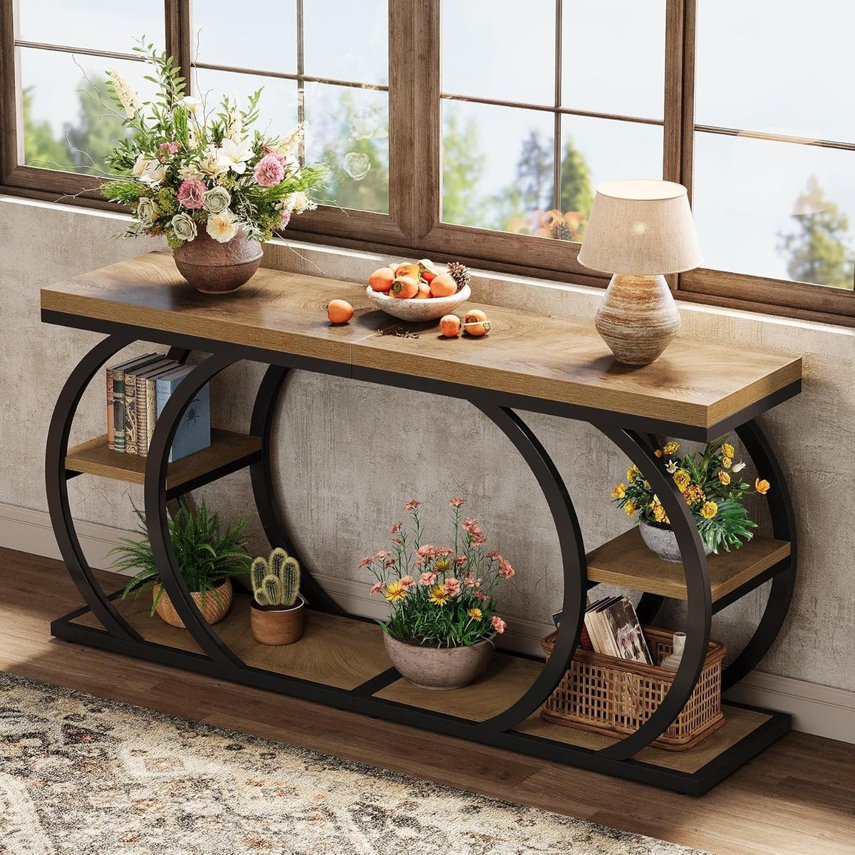 Three tier C table styled with plants and baskets against a wall