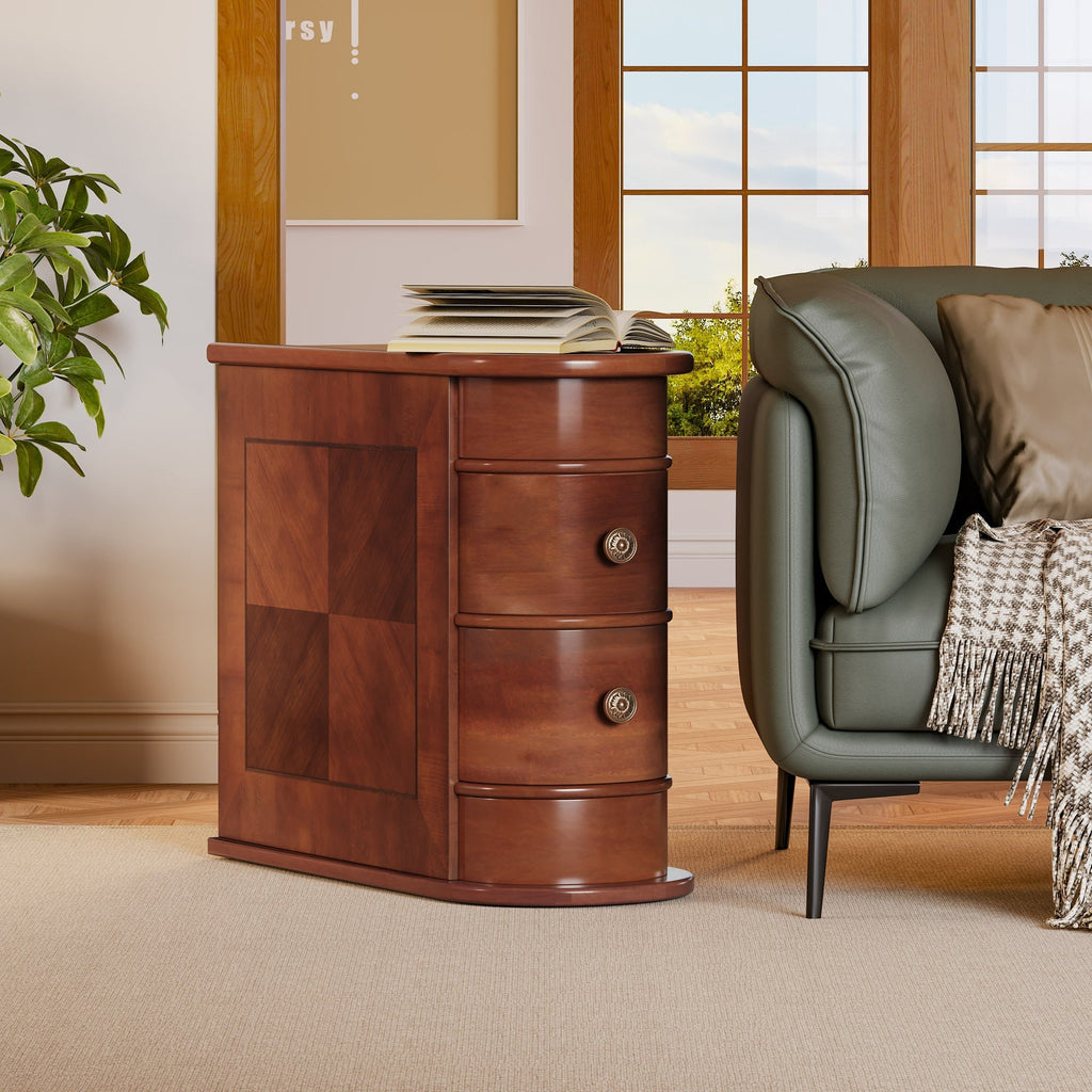 Walnut end table with two drawers standing beside a green armchair in a bright room
