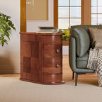 Walnut end table with two drawers standing beside a green armchair in a bright room