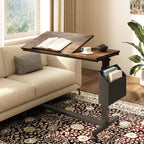 C table over a sofa with the tilting section holding an open book and a cup on the flat section