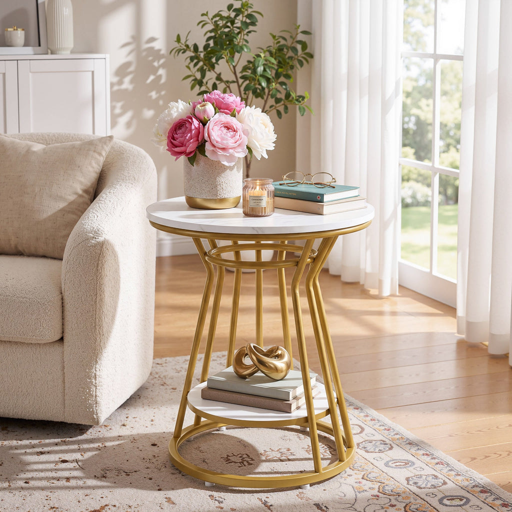 Stowena round faux marble end table with gold frame holding flowers by a cream sofa