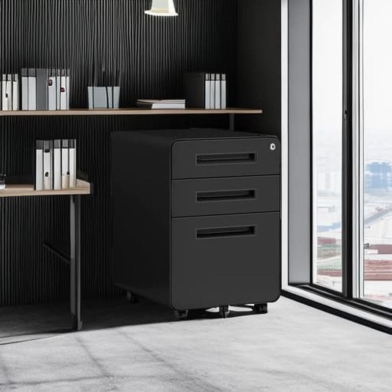 Black 3 drawer mobile file cabinet rolled under a wooden desk in a dark modern home office