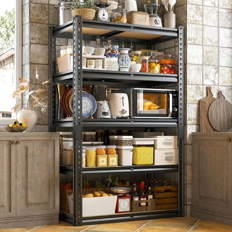 Black and wood 5 tier rack in a kitchen pantry holding jars, a microwave, canisters and dishes