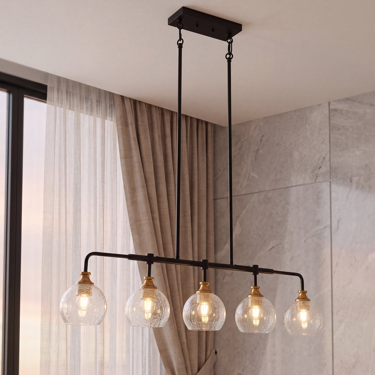 The crackle glass chandelier hanging on long rods beside a curtained window