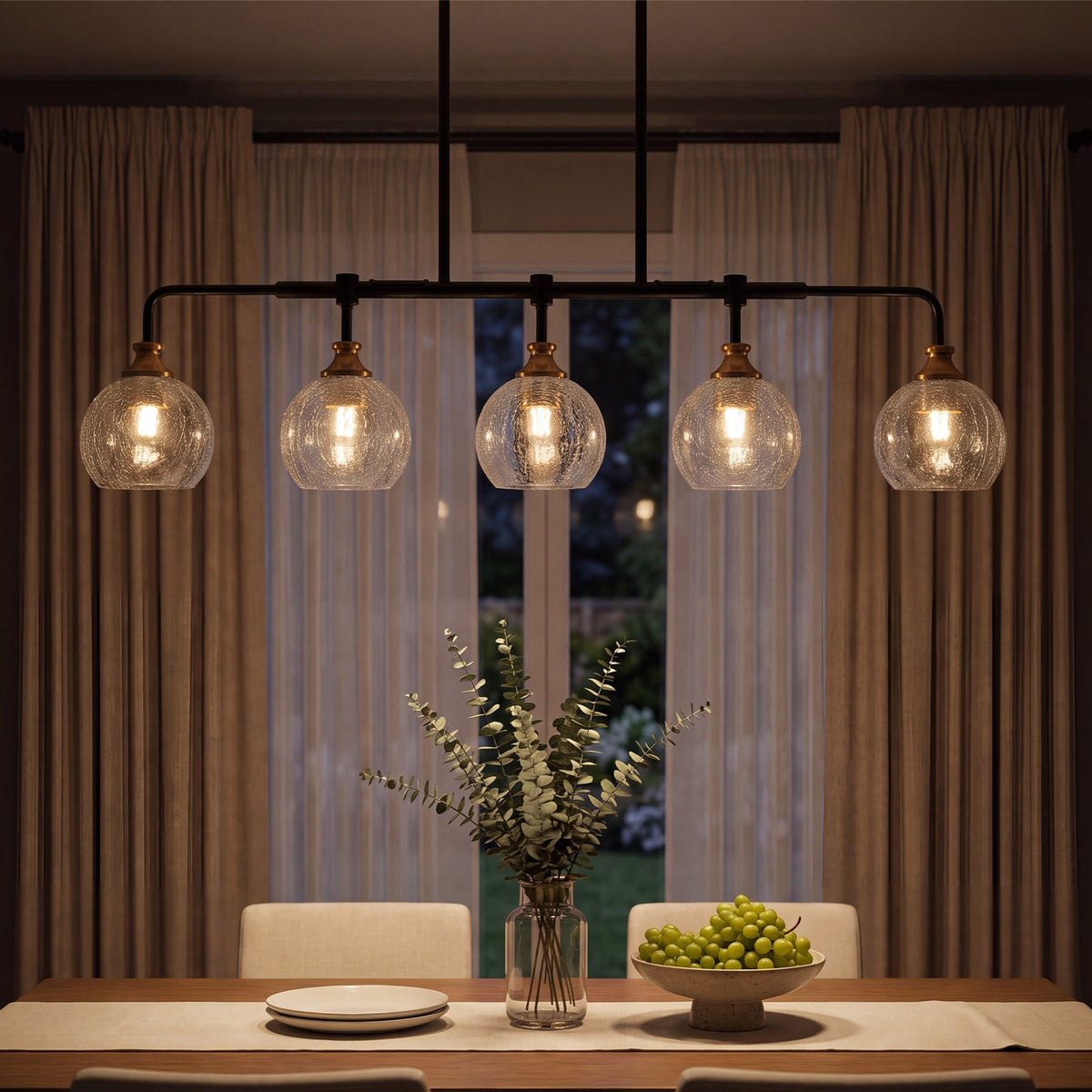 The five globes lit above a dining table at night