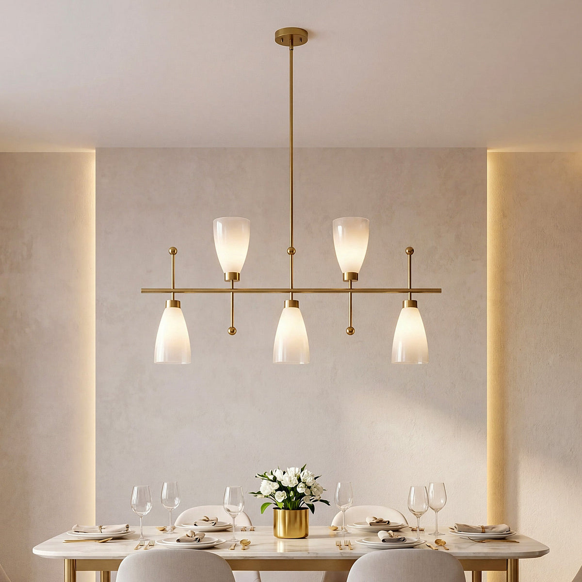 The chandelier lit above a set dining table against a plain plaster wall