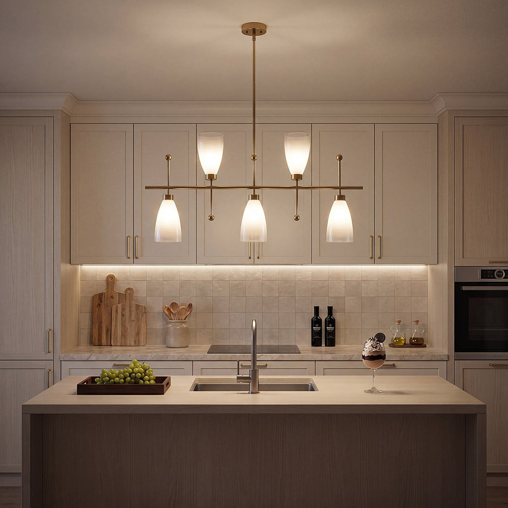 The fixture lit above a kitchen island in a cream shaker kitchen at night