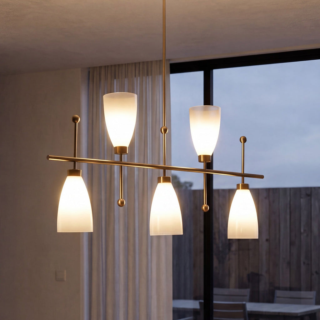 Close view of the brushed brass bar and gradient shades beside a glazed wall at dusk