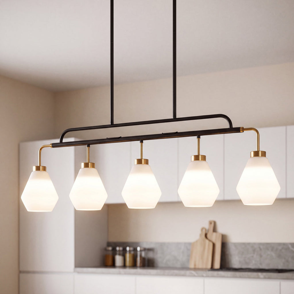 Five light pendant with frosted white diamond shades lit above a kitchen island