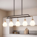 Five light pendant with frosted white diamond shades lit above a kitchen island