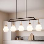 Five light pendant with frosted white diamond shades lit above a kitchen island