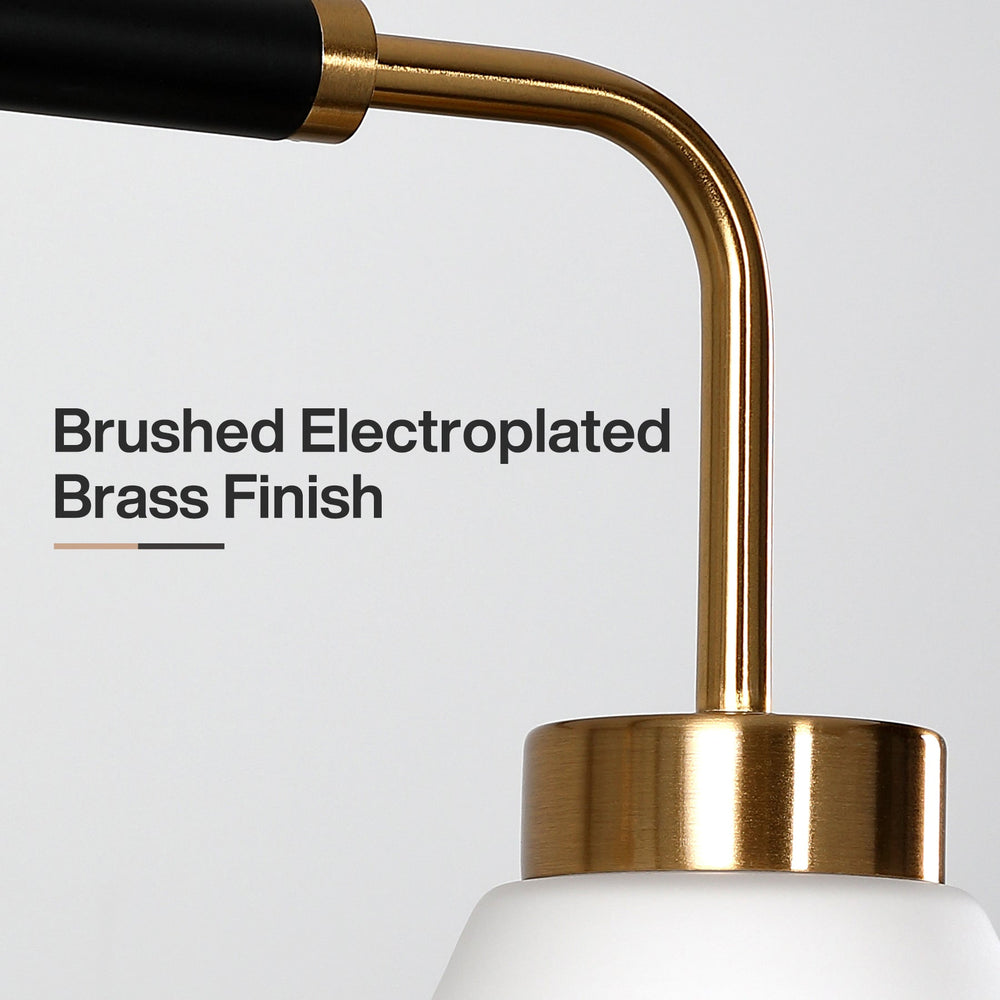 Close view of the brushed brass arm and collar meeting the frosted shade