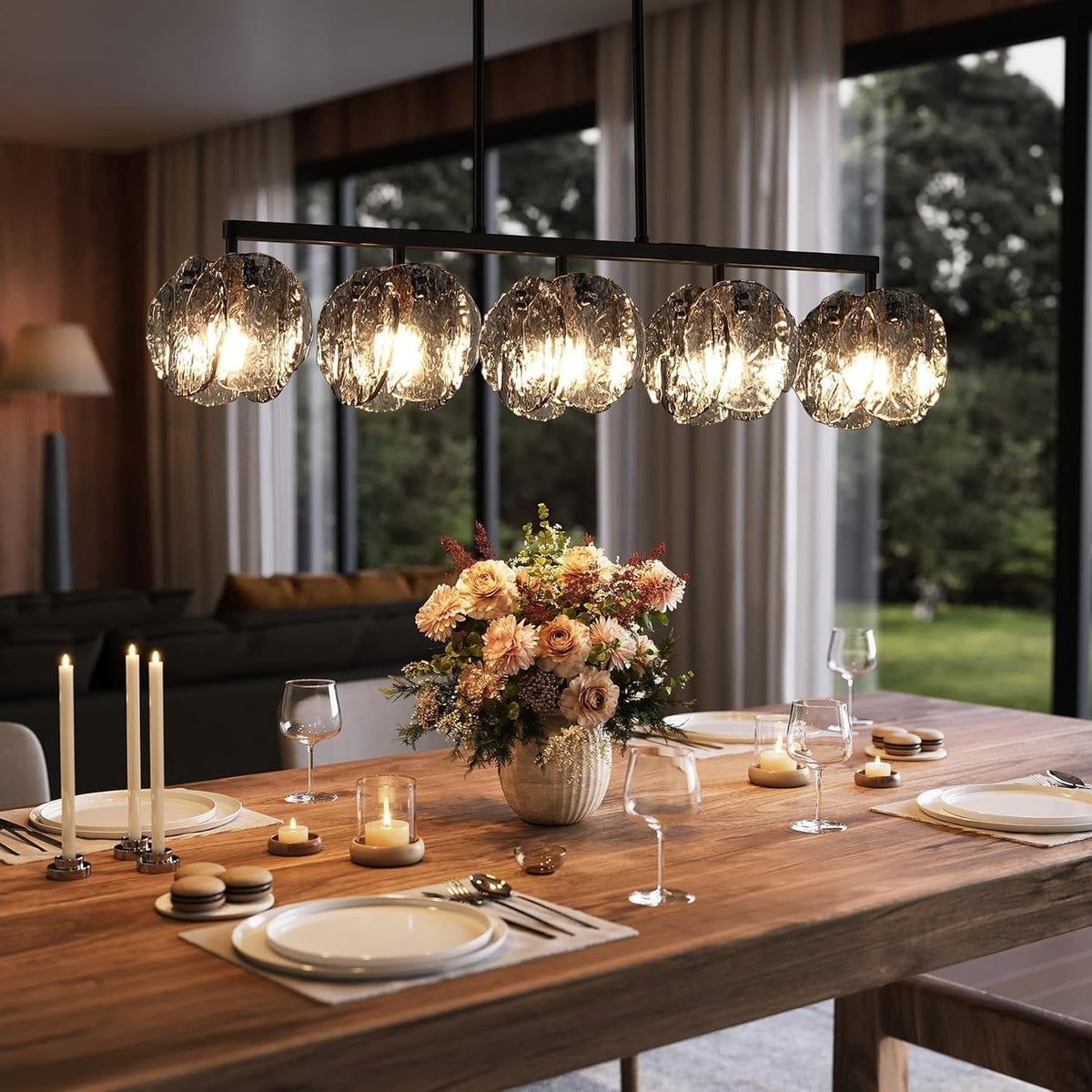 Five light linear chandelier with smoky gray layered glass shades lit above a wooden dining table