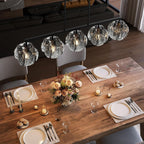Overhead view of the chandelier lit above a set dining table