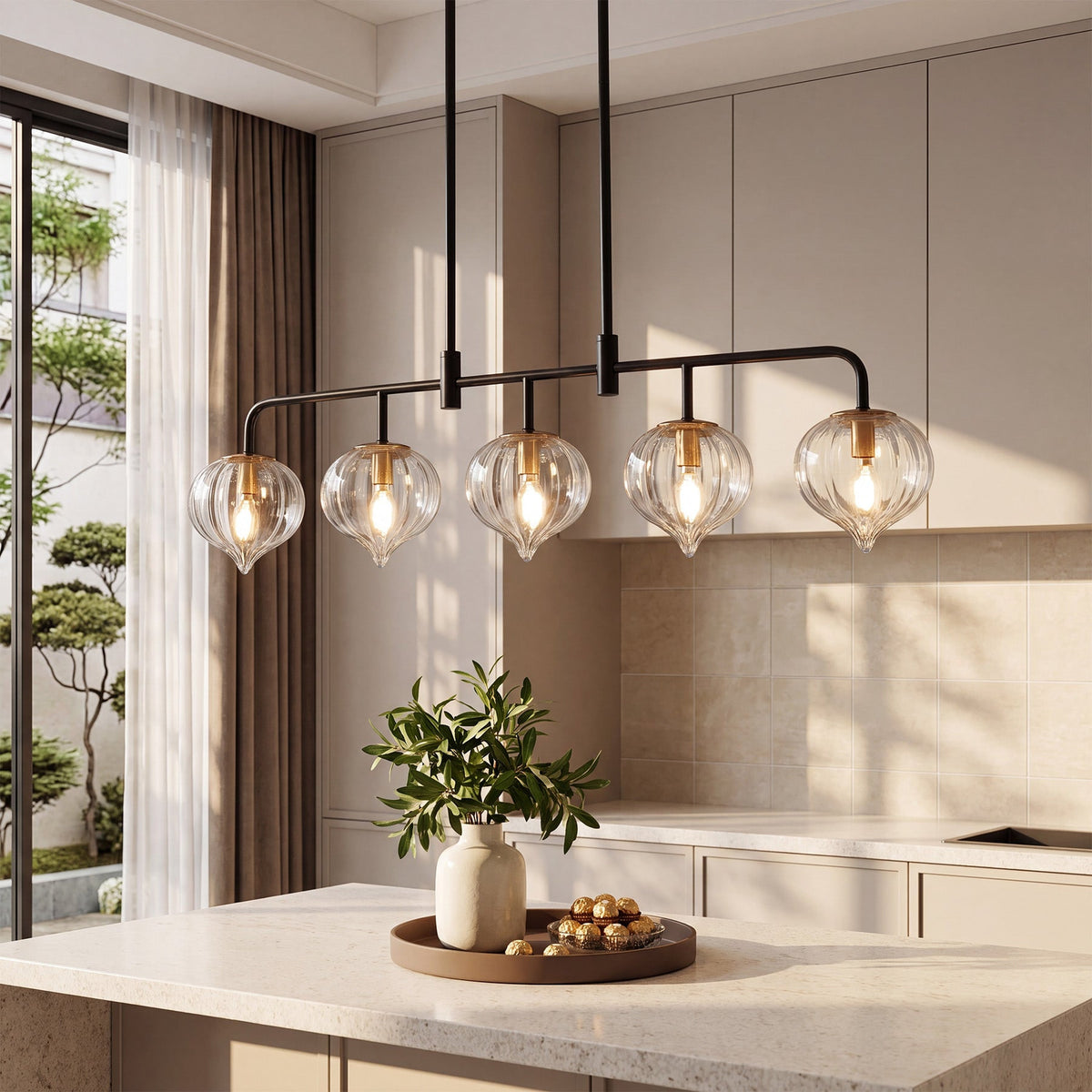 Five light pendant with clear ribbed teardrop shades lit above a kitchen island