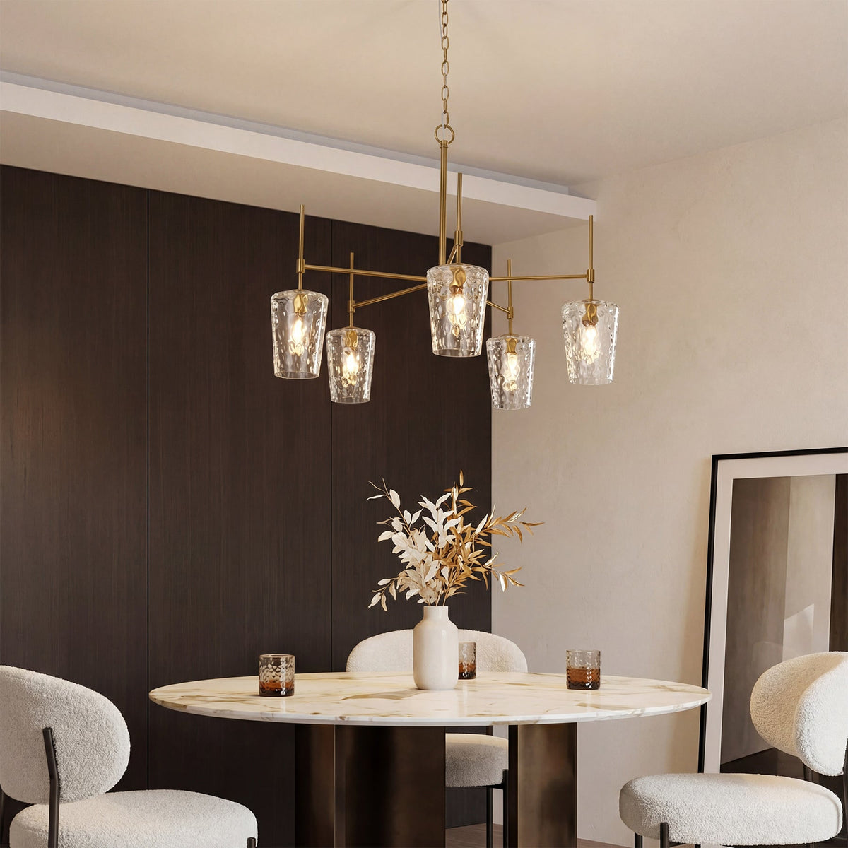 The gold chandelier over a marble table in a modern dining room