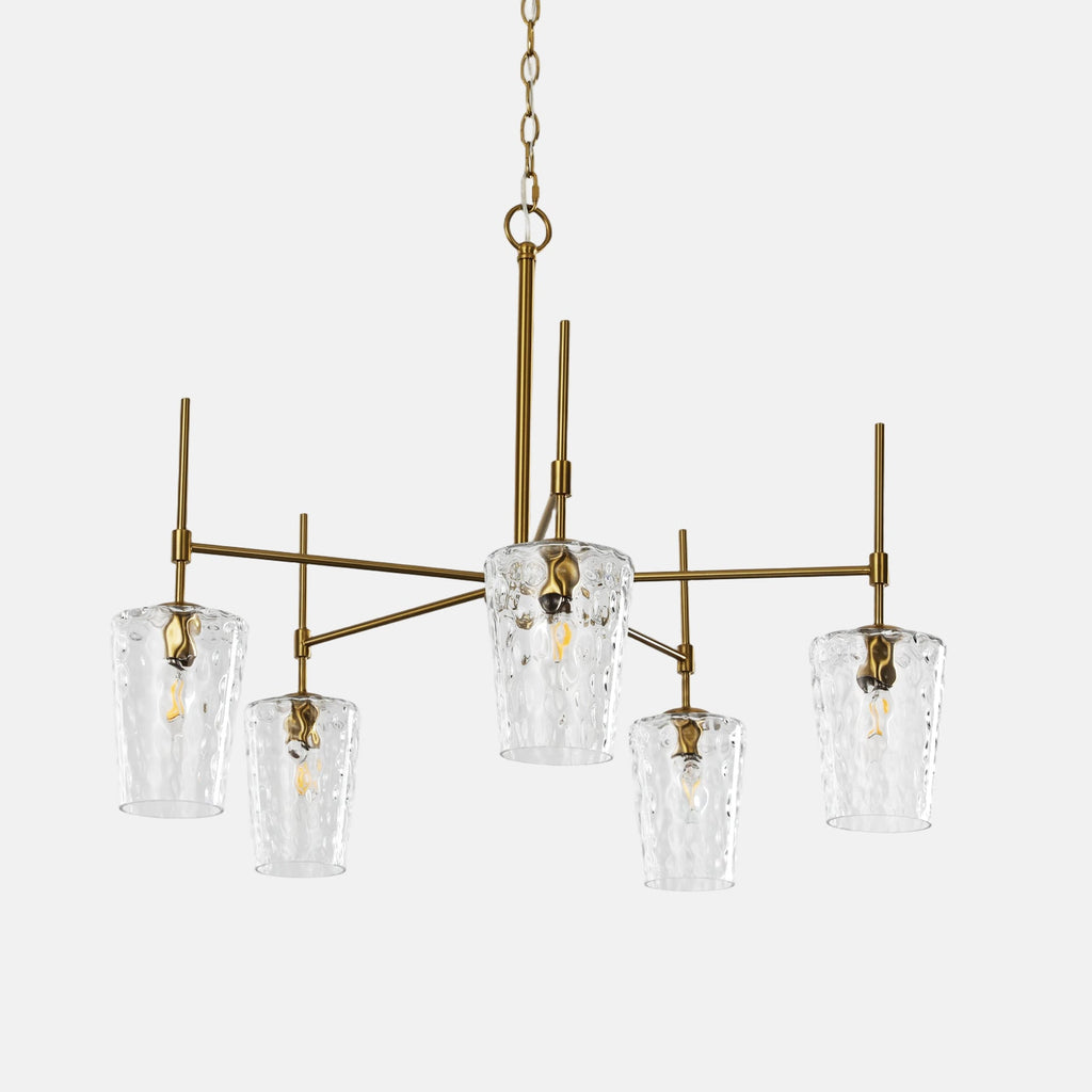 The five arm gold chandelier with hammered shades against a plain background