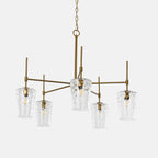 The five arm gold chandelier with hammered shades against a plain background