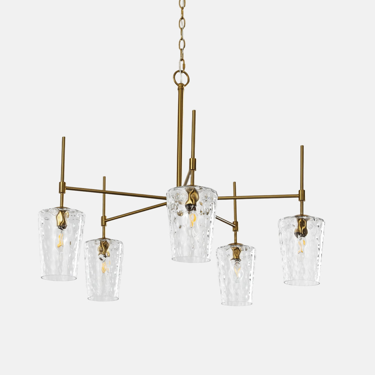 The five arm gold chandelier with hammered shades against a plain background