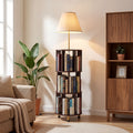 Stowena 62 inch floor lamp with 3 tier bookshelf lit beside an armchair