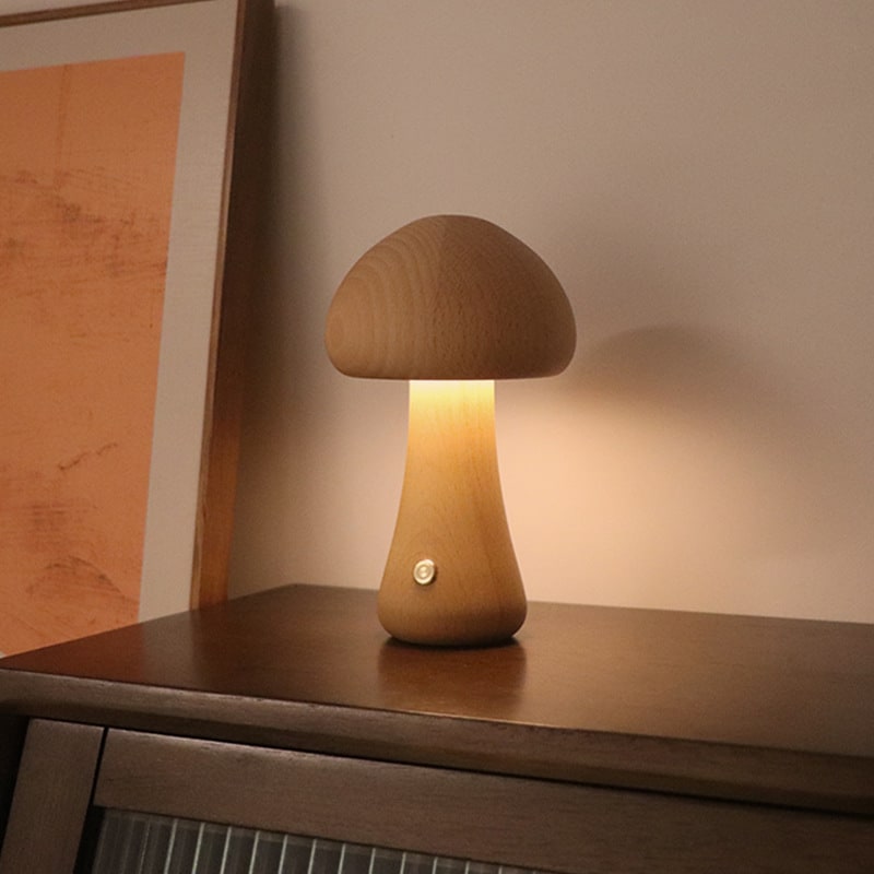 Wooden mushroom night light lit beside a picture frame, view 2