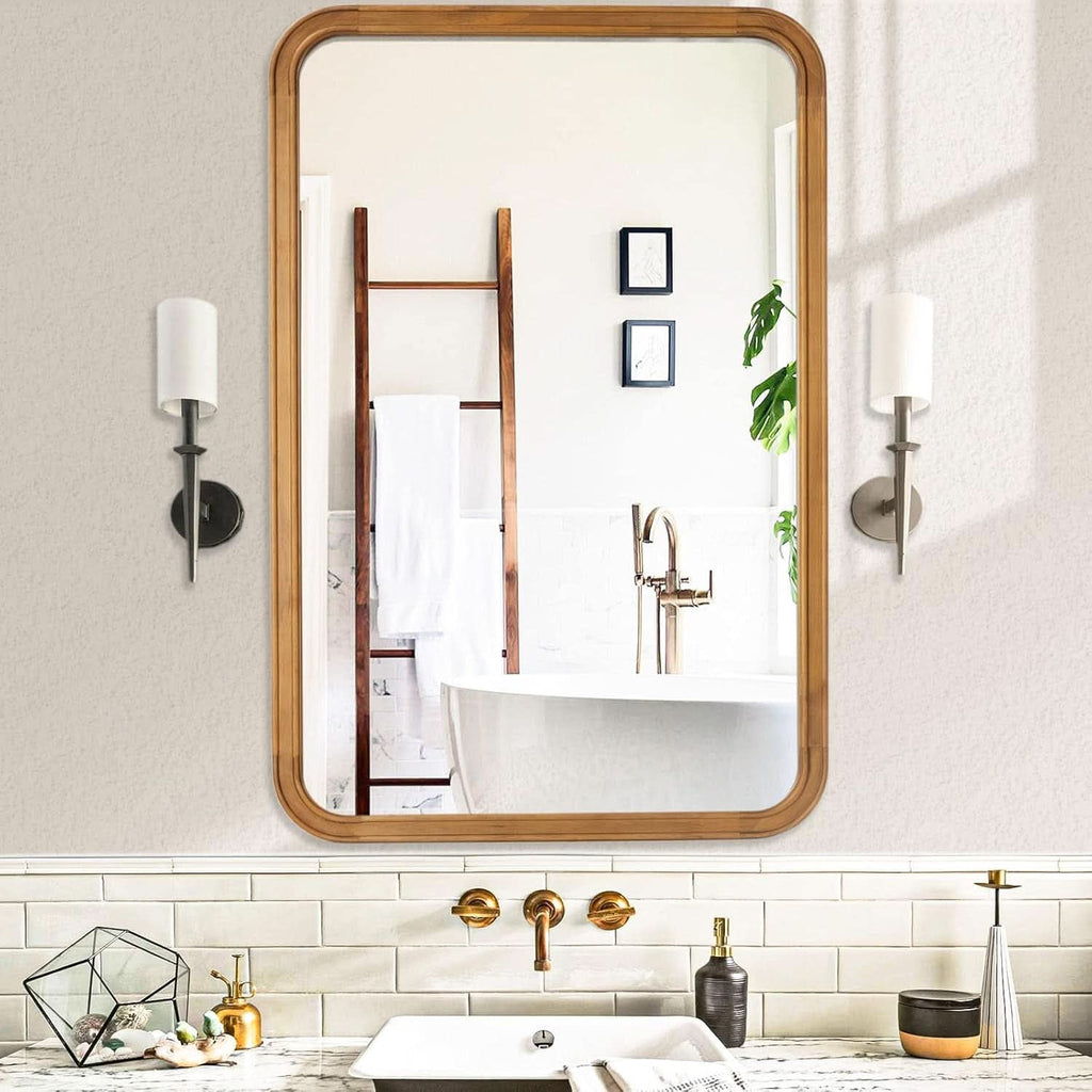 Wood framed rectangular mirror above a bathroom basin between two wall lights