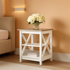Stowena rustic ivory X frame nightstand with flowers beside a beige sofa