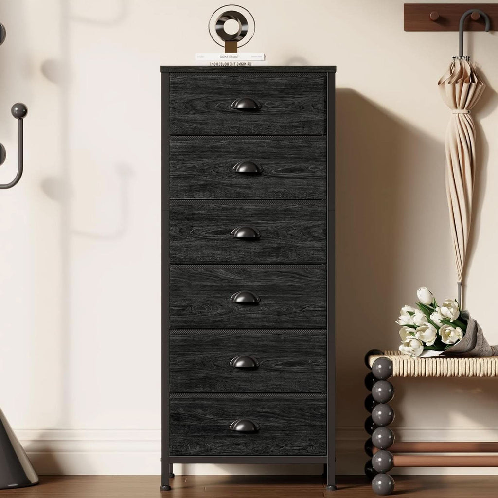 The six drawer tower in a hallway beside a coat hook with an umbrella and decor