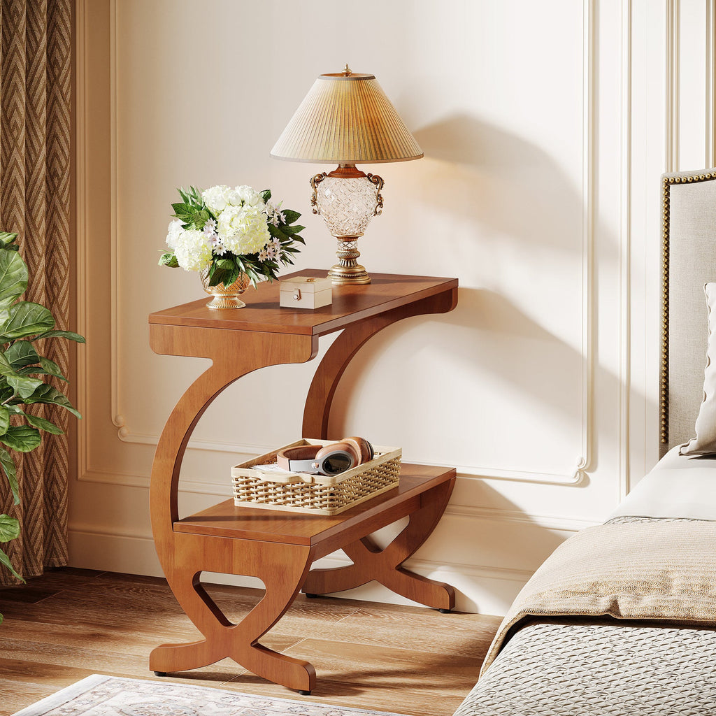 Walnut nightstand beside a bed holding a lamp and a woven tray
