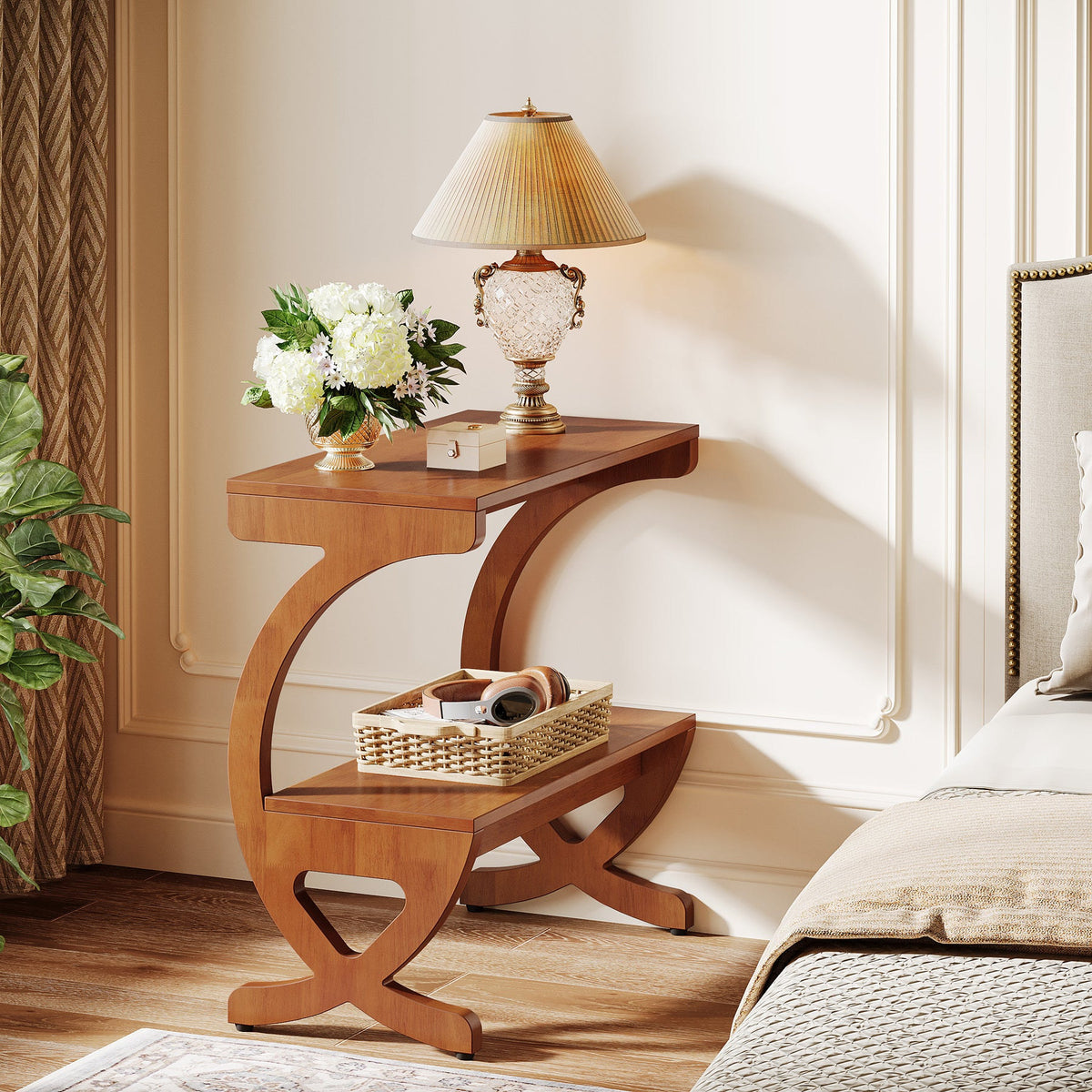 Walnut nightstand beside a bed holding a lamp and a woven tray