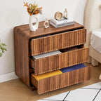 All three drawers open showing folded clothes inside the walnut chest