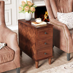 Three drawer side table by a fireplace holding coffee and flowers