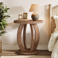 Stowena round nightstand with storage beside a bed holding a lamp and clock