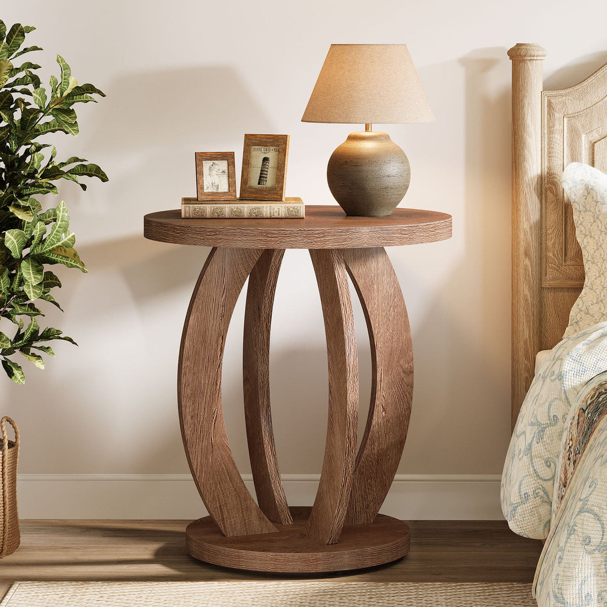Stowena round nightstand with storage beside a bed holding a lamp and clock