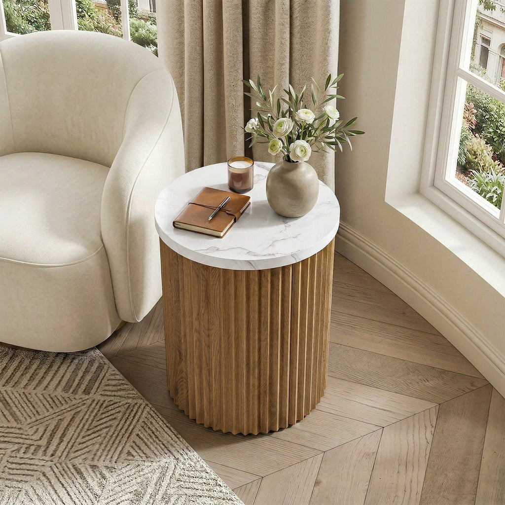 Fluted drum table beside a boucle armchair in a bright corner