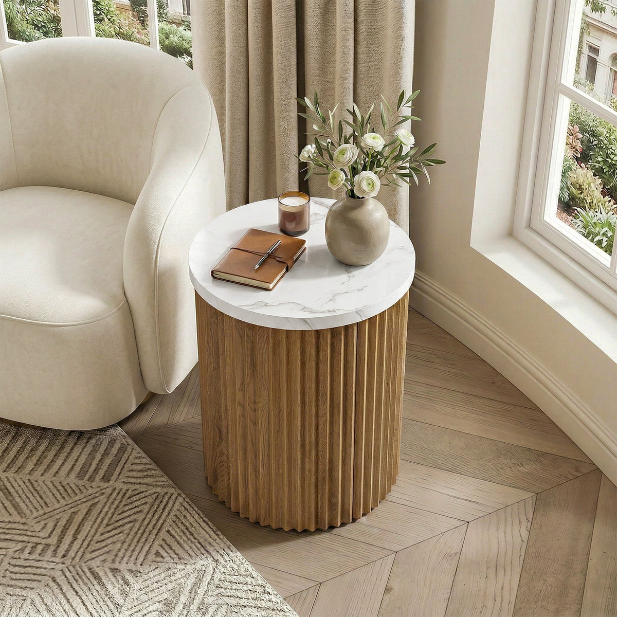 Fluted drum table beside a boucle armchair in a bright corner