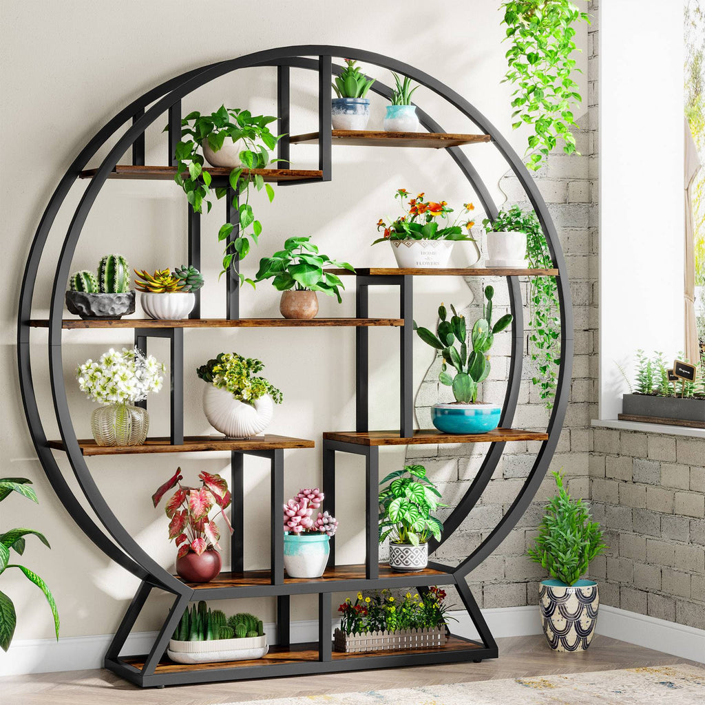 Round eight shelf plant stand in rustic brown holding potted plants against a brick wall