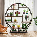 The plant stand beside an armchair with plants on all eight staggered shelves