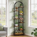 Stowena 8 tier arched plant shelf full of plants by a living room window