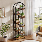 Tall arched plant shelf in a bright corner with trailing plants